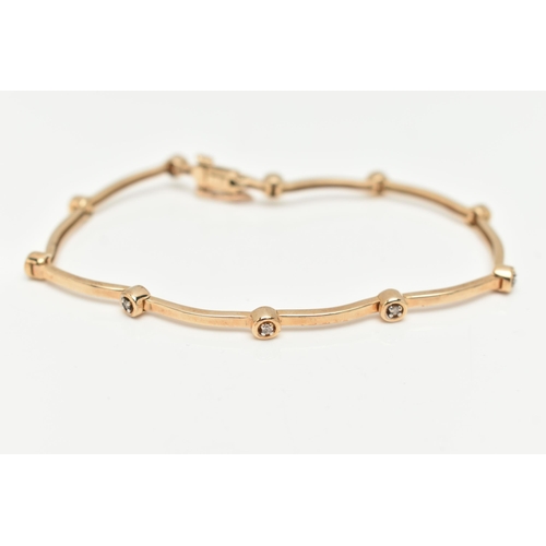 113 - A 9CT YELLOW GOLD DIAMOND BRACELET, designed as a series of ten round brilliant cut diamonds, inters... 