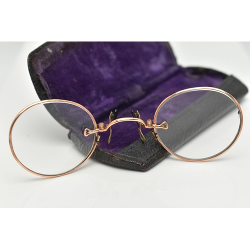 114 - A PAIR OF EARLY 20TH CENTURY YELLOW METAL SPECTACLE GLASSES WITH CASE, the spectacles with plain yel... 