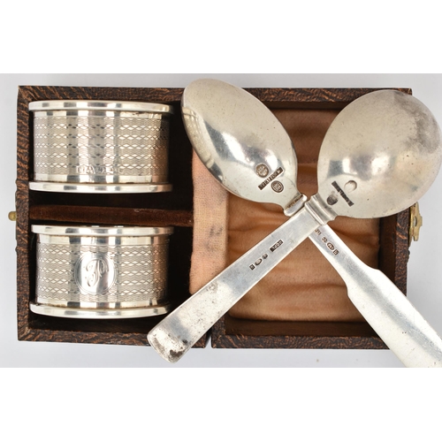 125 - A CASED PAIR OF SILVER NAPKIN RINGS AND TWO SPOONS, engine turned pattern napkin rings with engraved... 