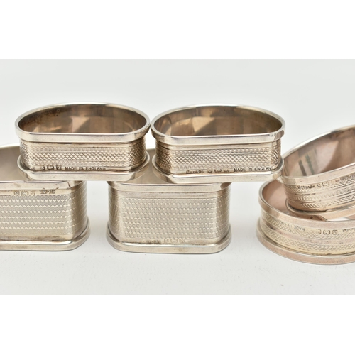 126 - THREE PAIRS OF SILVER NAPKIN RINGS, to include a pair of circular engine turned pattern napkin rings... 