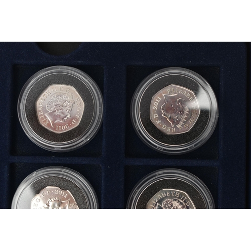 134 - A BOX OF ROYAL MINT COMMEMORATIVE SILVER 50 PENCE COINS, to include eleven coins, from the Olympic '... 