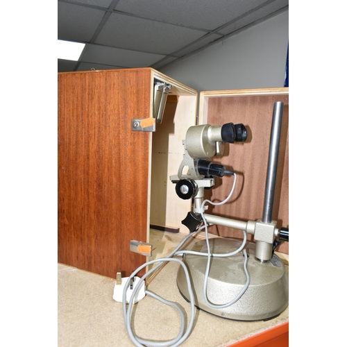 363 - A CASED PRIOR ELECTRIC BINOCULAR MICROSCOPE, the case containing two additional lenses, not tested (... 