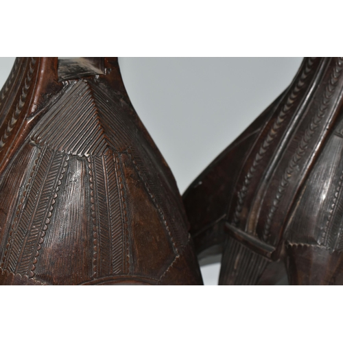 466 - A PAIR OF WOODEN STIRRUPS, carved with patterns, each with six wooden 'legs', approximate measuremen... 