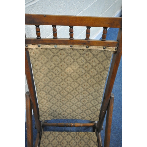 1309 - A 20TH CENTURY FOLDING ROCKING CHAIR, with beige fabric back and seat (condition report: surface mar... 