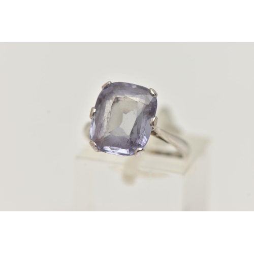 22 - A GEM SET RING, an elongated cushion cut bule stone, assessed as synthetic sapphire, prong set in wh... 