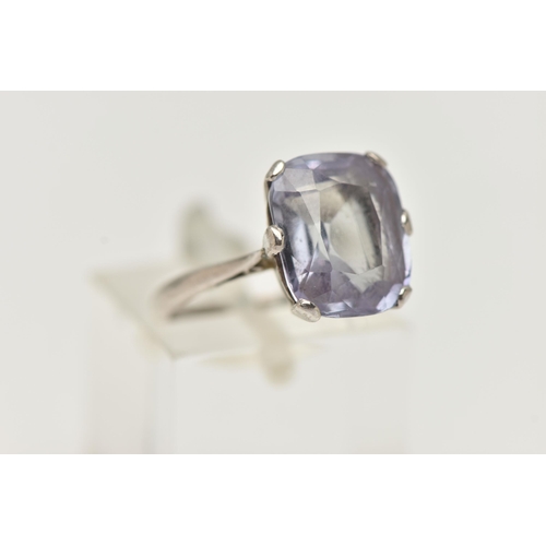 22 - A GEM SET RING, an elongated cushion cut bule stone, assessed as synthetic sapphire, prong set in wh... 