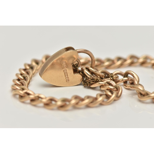 24 - A 9CT GOLD BRACELET, the curb link bracelet with heart padlock clasp, 9ct hallmark on clasp and brac... 