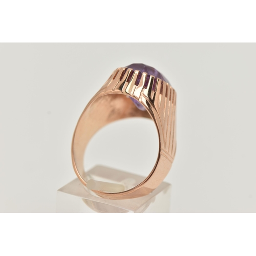 25 - A SYNTHETIC COLOUR CHANGE SAPPHIRE SIGNET RING, designed as an oval purple synthetic colour change s... 