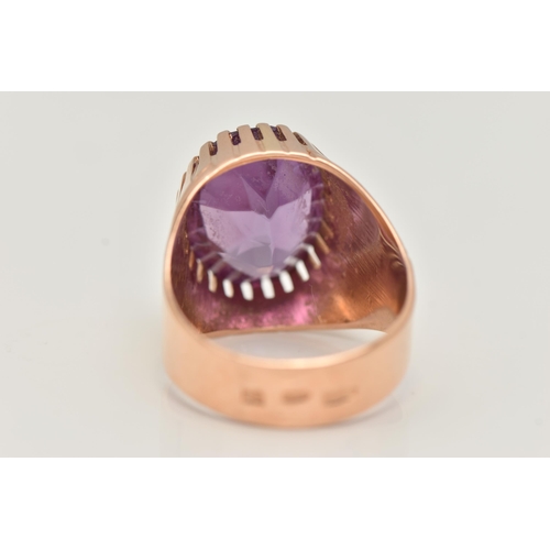 25 - A SYNTHETIC COLOUR CHANGE SAPPHIRE SIGNET RING, designed as an oval purple synthetic colour change s... 