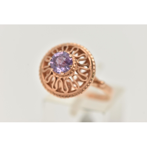 26 - A DECORATIVE SYNTHETIC COLOUR CHANGE SAPPHIRE RING, designed as a circular purple synthetic colour c... 