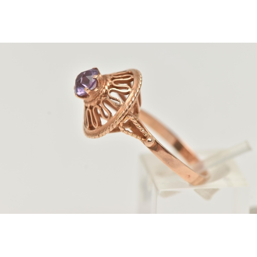 26 - A DECORATIVE SYNTHETIC COLOUR CHANGE SAPPHIRE RING, designed as a circular purple synthetic colour c... 