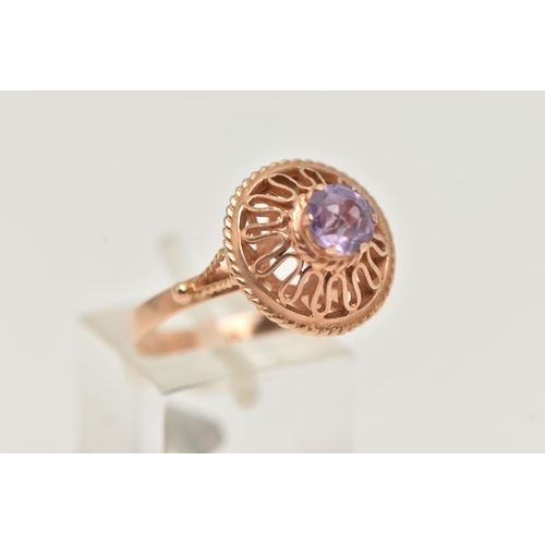 26 - A DECORATIVE SYNTHETIC COLOUR CHANGE SAPPHIRE RING, designed as a circular purple synthetic colour c... 