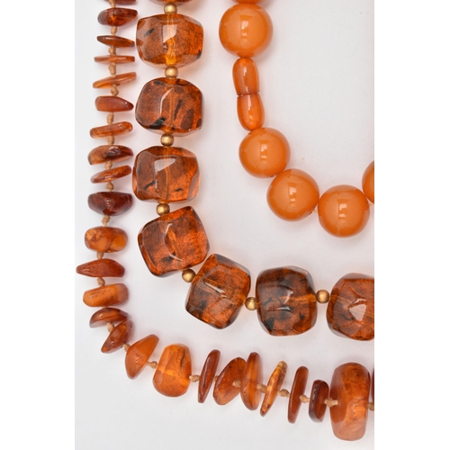 44 - FOUR NECKLACES, to include a branch coral necklace, a heated amber necklace, and two plastic bead ne... 