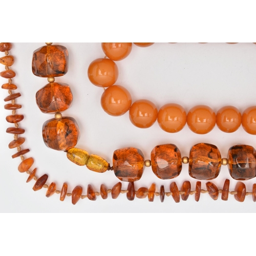 44 - FOUR NECKLACES, to include a branch coral necklace, a heated amber necklace, and two plastic bead ne... 