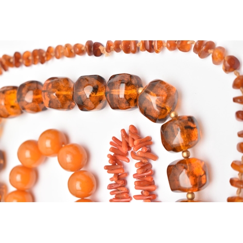 44 - FOUR NECKLACES, to include a branch coral necklace, a heated amber necklace, and two plastic bead ne... 