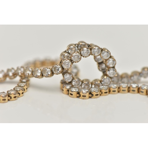 45 - A YELLOW METAL CUBIC ZIRCONIA TENNIS BRACELET, designed as a series of colourless circular cut cubic... 