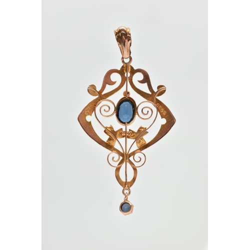 49 - AN EDWARDIAN GEM SET PENDANT, the openwork scrolling design pendant set with a central oval blue gar... 