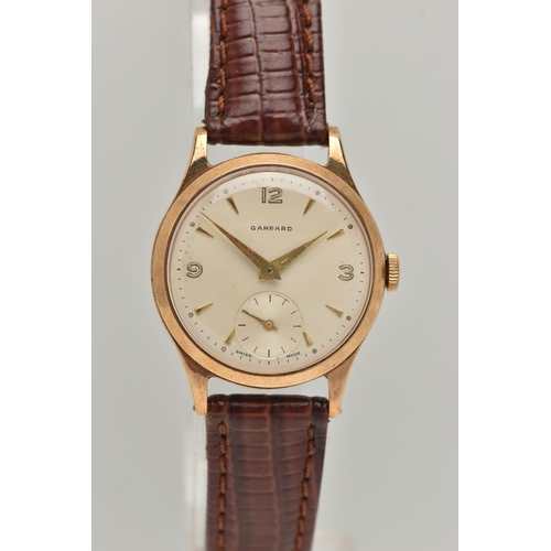 58 - A GARRARD 9CT WRISTWATCH, the circular face with baton and Arabic numerals, a subsidiary seconds dia... 