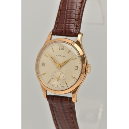 58 - A GARRARD 9CT WRISTWATCH, the circular face with baton and Arabic numerals, a subsidiary seconds dia... 