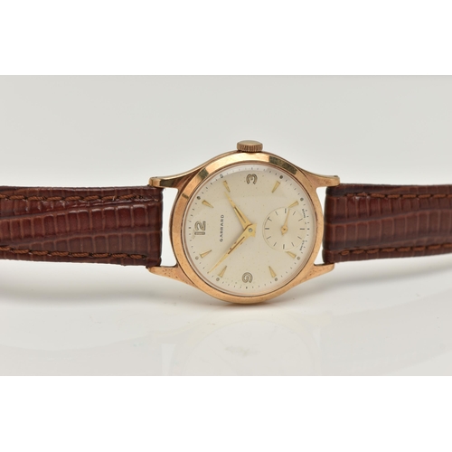 58 - A GARRARD 9CT WRISTWATCH, the circular face with baton and Arabic numerals, a subsidiary seconds dia... 