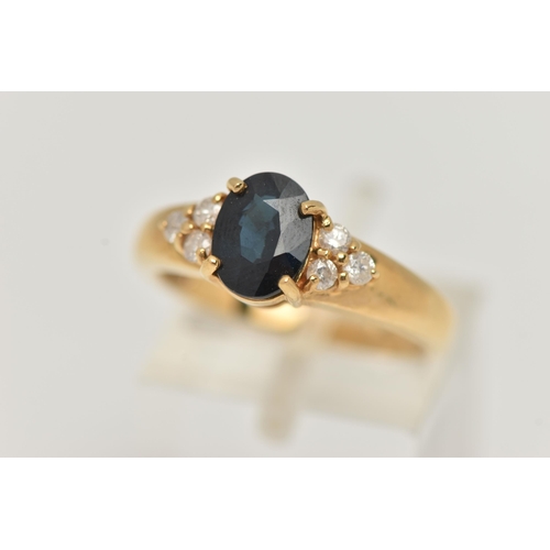 60 - AN 18CT GOLD SAPPHIRE AND DIAMOND RING, the central oval sapphire flanked by three brilliant cut dia... 