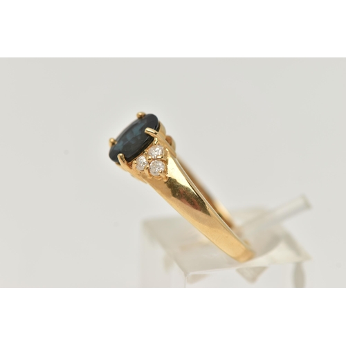 60 - AN 18CT GOLD SAPPHIRE AND DIAMOND RING, the central oval sapphire flanked by three brilliant cut dia... 