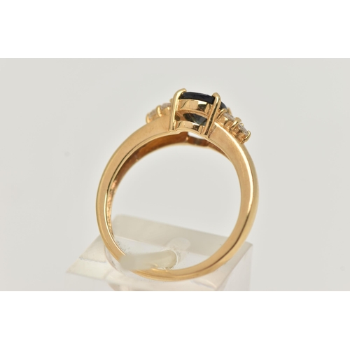 60 - AN 18CT GOLD SAPPHIRE AND DIAMOND RING, the central oval sapphire flanked by three brilliant cut dia... 