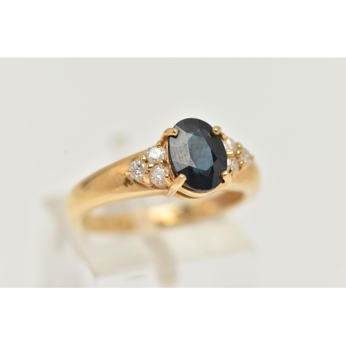 60 - AN 18CT GOLD SAPPHIRE AND DIAMOND RING, the central oval sapphire flanked by three brilliant cut dia... 