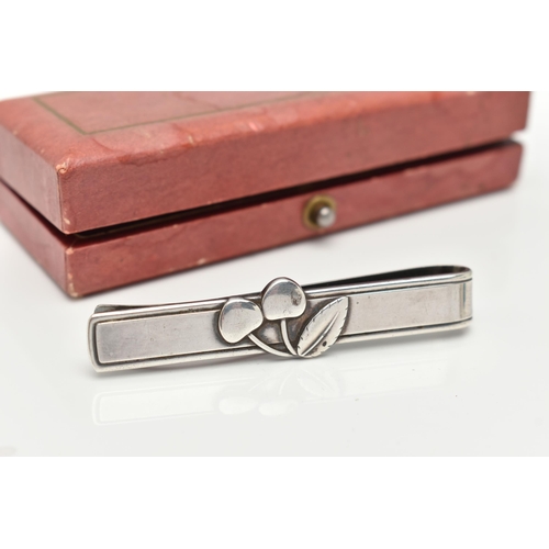 68 - A 'GEORG JENSEN' 'CHERRY HEERING' TIE CLIP, designed as a pair of cherries to the plain bar for the ... 