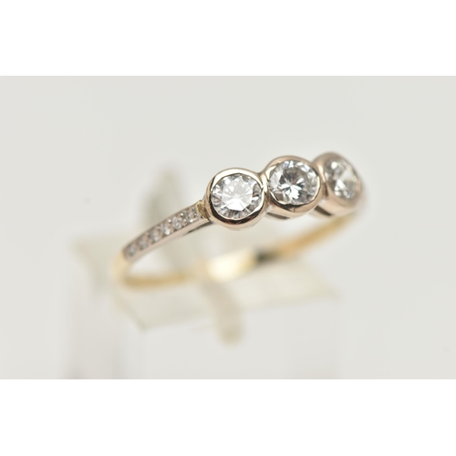 7 - A THREE STONE DIAMOND RING, three round brilliant cut diamonds bezel set in white metal, approximate... 