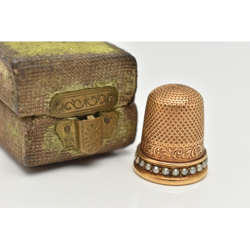 120 - A LATE VICTORIAN YELLOW METAL THIMBLE, textured detail and a split pearl rim, unmarked, approximate ... 