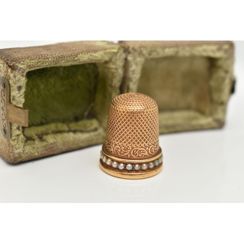 120 - A LATE VICTORIAN YELLOW METAL THIMBLE, textured detail and a split pearl rim, unmarked, approximate ... 