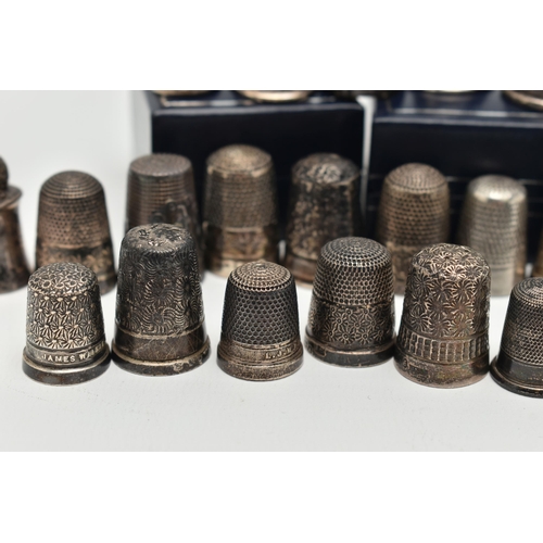 140 - A SELECTION OF SILVER THIMBLES, twenty-six thimbles in total, various designs and patterns, all with... 