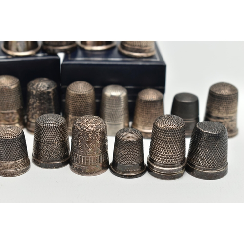 140 - A SELECTION OF SILVER THIMBLES, twenty-six thimbles in total, various designs and patterns, all with... 