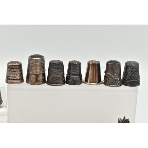 142 - A BAG OF WHITE METAL THIMBLES, various designs and patterns, some set with semi-precious stone termi... 