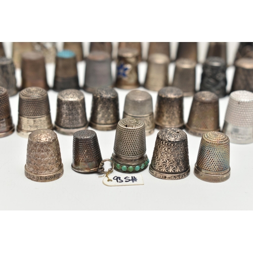 142 - A BAG OF WHITE METAL THIMBLES, various designs and patterns, some set with semi-precious stone termi... 