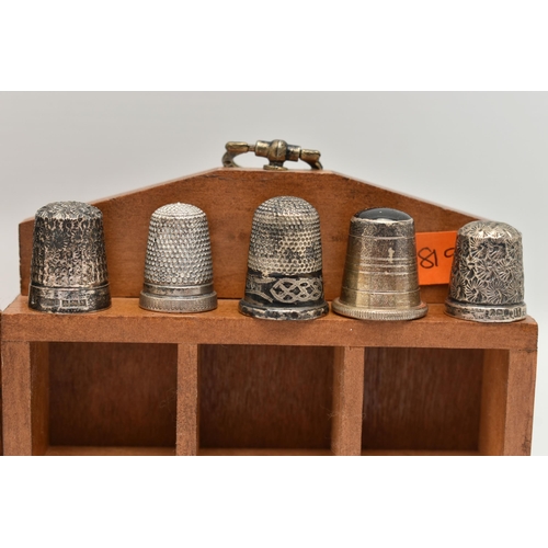 146 - A SELECTION OF SILVER THIMBLES AND TWO DISPLAY UNITS, to include twenty-two thimbles, various design... 