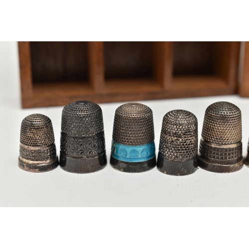 146 - A SELECTION OF SILVER THIMBLES AND TWO DISPLAY UNITS, to include twenty-two thimbles, various design... 