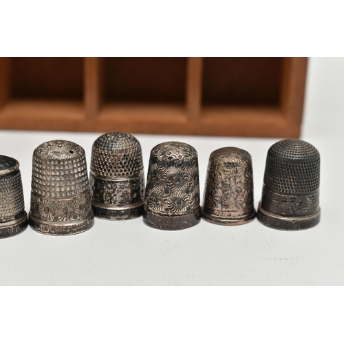 146 - A SELECTION OF SILVER THIMBLES AND TWO DISPLAY UNITS, to include twenty-two thimbles, various design... 