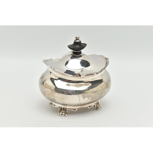 149 - A GEORGE V SILVER TEA CADDY OF OVAL FORM, the hinged cover fitted with an ebony finial, on four paw ... 