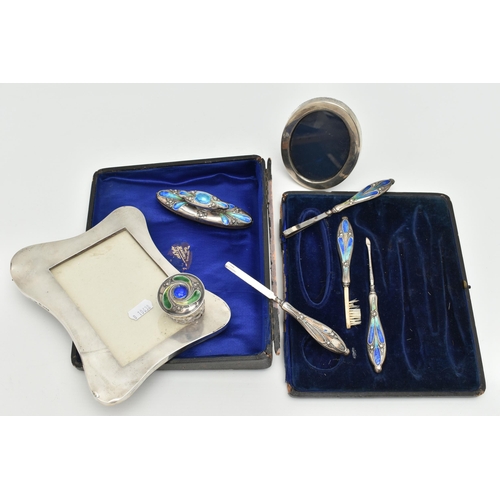 170 - TWO SILVER PHOTO FRAMES AND AN INCOMPLETE MANICURE SET, the first an early 20th century, polished wa... 