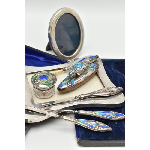 170 - TWO SILVER PHOTO FRAMES AND AN INCOMPLETE MANICURE SET, the first an early 20th century, polished wa... 