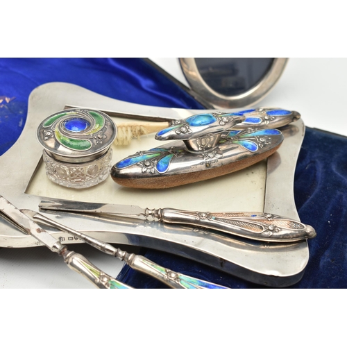 170 - TWO SILVER PHOTO FRAMES AND AN INCOMPLETE MANICURE SET, the first an early 20th century, polished wa... 