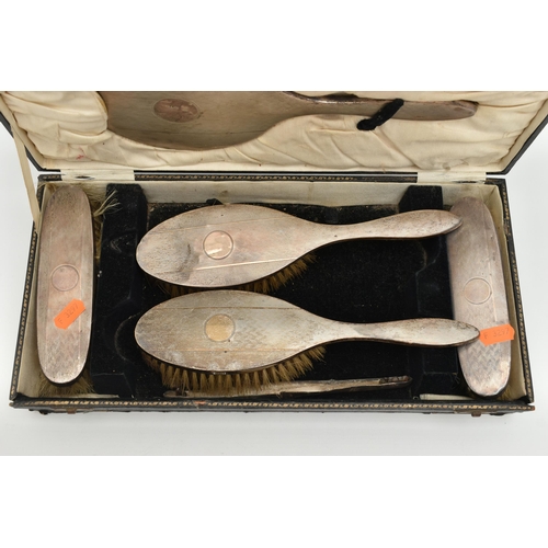 173 - A CASED SILVER VANITY SET, to include four brushes and a mirror (comb is missing), engine turned pat... 