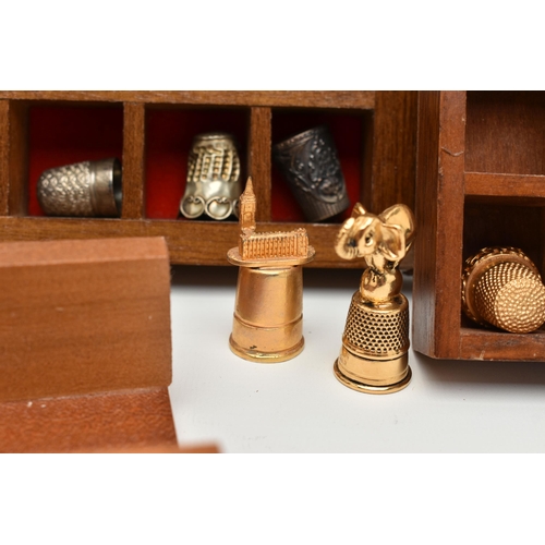 177 - ASSORTED WHITE METAL THIMBLES AND THIMBLE DISPLAY CASES, to include a wooden fifty piece wall hangin... 