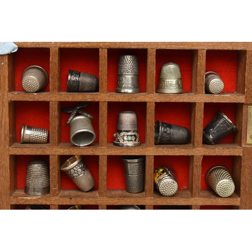 177 - ASSORTED WHITE METAL THIMBLES AND THIMBLE DISPLAY CASES, to include a wooden fifty piece wall hangin... 