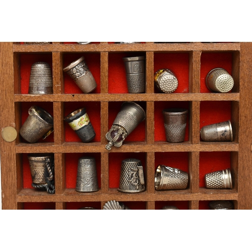 177 - ASSORTED WHITE METAL THIMBLES AND THIMBLE DISPLAY CASES, to include a wooden fifty piece wall hangin... 