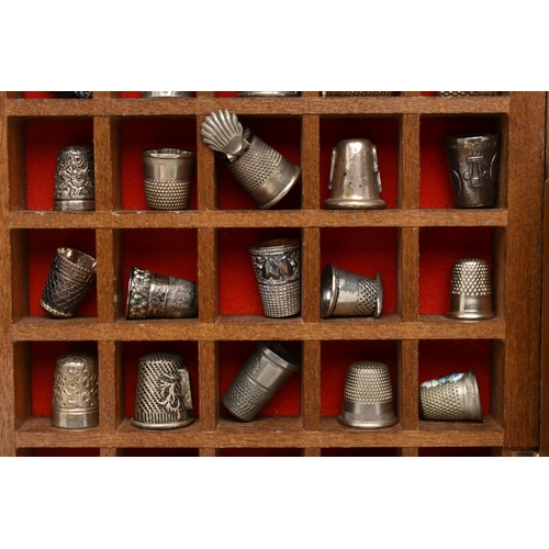 177 - ASSORTED WHITE METAL THIMBLES AND THIMBLE DISPLAY CASES, to include a wooden fifty piece wall hangin... 