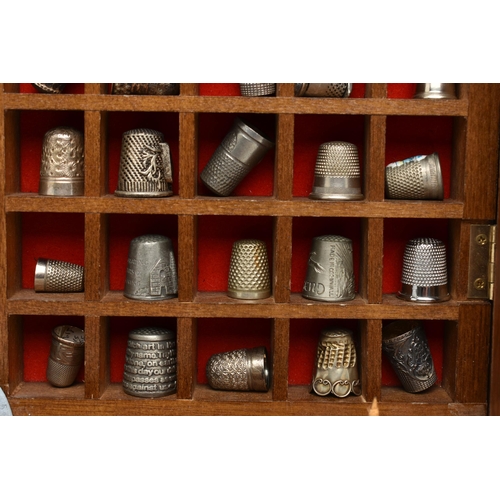 177 - ASSORTED WHITE METAL THIMBLES AND THIMBLE DISPLAY CASES, to include a wooden fifty piece wall hangin... 