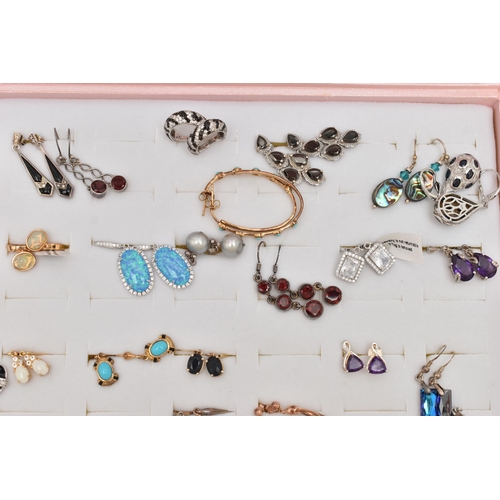 179 - A PINK JEWELLERY DISPLAY BOX WITH EARRINGS, forty eight pairs included, various designs, some pieces... 